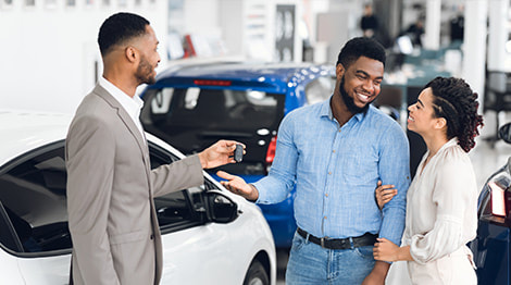 Happy couple talking to car agent photo